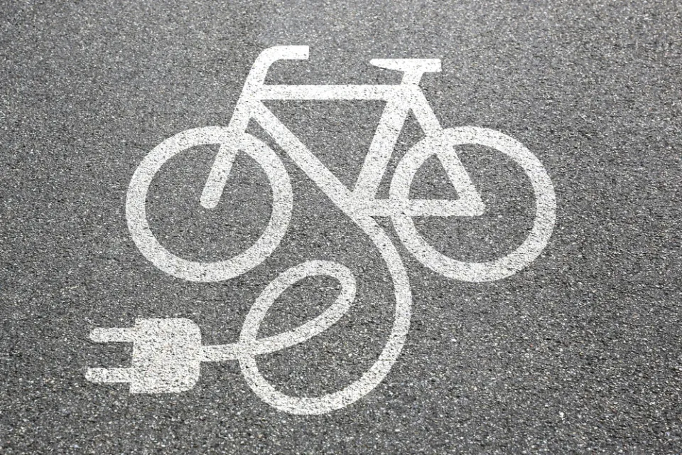 Electric bike charging logo on asphalt